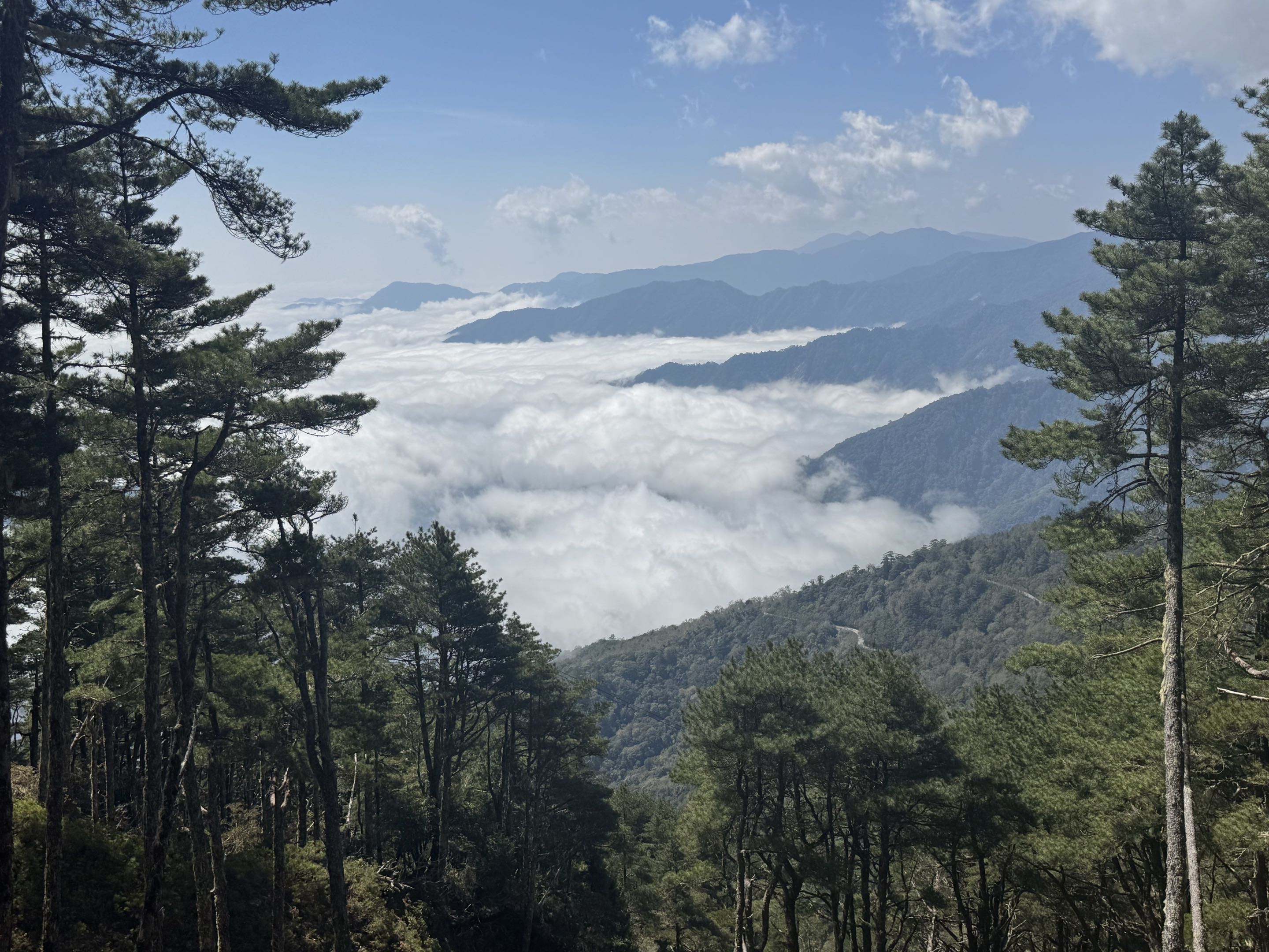 View of the mountain rising above cumulus clouds